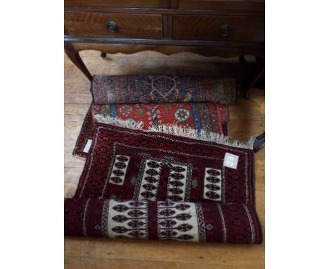 A Kazak style rug, 287 x 87 cm, and two other rugs (3)