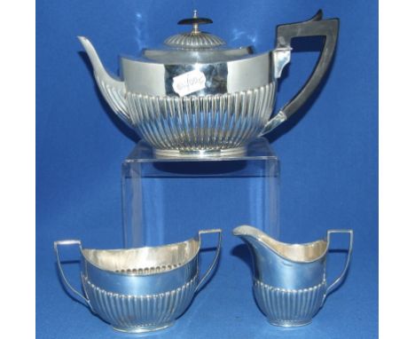 A George III style silver three piece tea service, with a reeded lower body, London 1895, approx. 27.9 ozt (all in) (3)