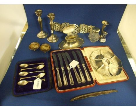 A silver capstan style inkwell, Birmingham 1914, 15 cm wide, a pair of silver candlesticks, other silver and plated items