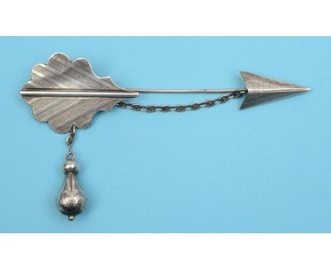 A 19th century silver cloak brooch, in the form of an arrow, with locking chain and drop, with engraved decoration, the rever