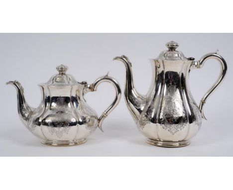 A Victorian silver coffee pot, crested and engraved a motto, with engraved decoration, and a matching teapot, London 1849/50,
