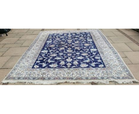 A Persian carpet, decorated stylised floral motifs, on a blue ground, 331 x 249 cm