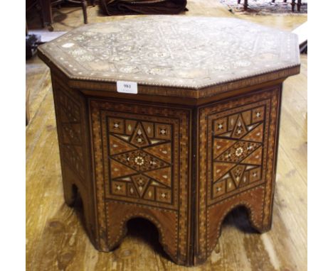 A Moorish style inlaid octagonal table (some loss), 58 cm wide Condition report Report by GH

The top has many areas of loss 