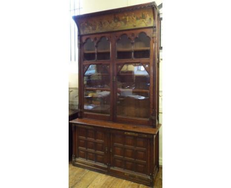 An Arts & Crafts oak library bookcase, the concave shaped cornice painted a frieze decorated musicians and other figures, abo