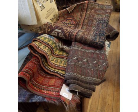 An Afghan rug, with elephant ghul motifs, on a red ground, 119.5 x 199 cm, and four other rugs (5)