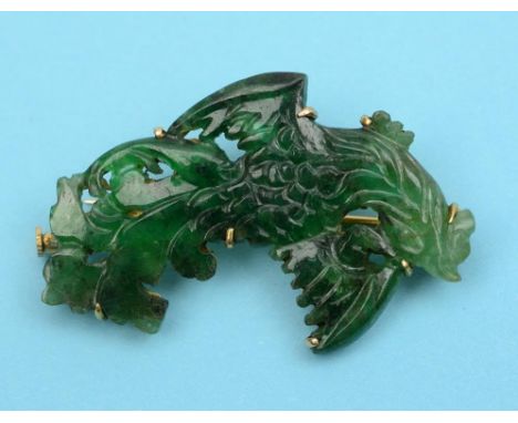 A carved and pierced jadeite jade bird, in a 14ct gold brooch mount, with certificate  See front cover colour illustration Co