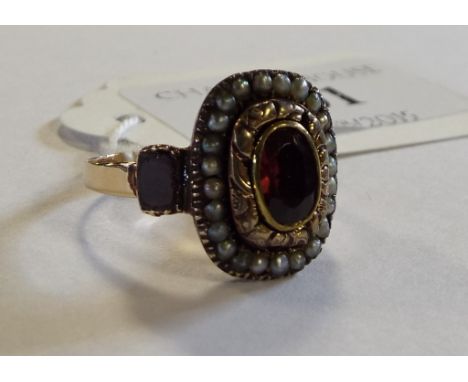 A yellow coloured metal, ruby and seed pearl ring