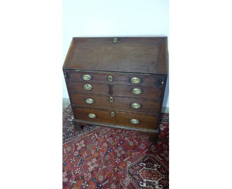 A Georgian Mahogany Bureau with a well fitted interior over three long and two short drawers - raised on bracket feet, width 