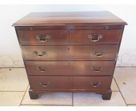 A Georgian mahogany chest with two short over three long drawers on bracket feet and with a brushing slide - recently re poli