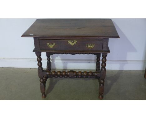 An 18th Century oak side table with a single drawer on bobbin turned supports and stretchers - 75 cm tall x 88 cm x 56 cm - s