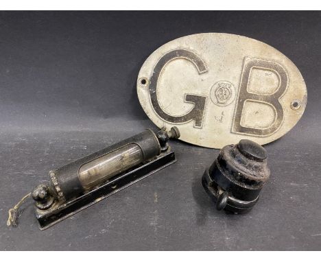 An AA GB plate, a dash mounted reading light and a bakelite switch. 