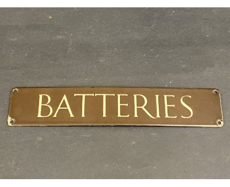 A small brown and cream coloured enamel sign for 'Batteries', 12 x 2 1/2". 