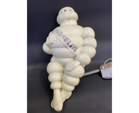 A Michelin Mr Bibendum figure, from an air pump, mounted on a bracket.