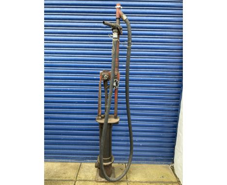 A Bowser Model 10c skeleton petrol pump in original unrestored condition, with rubber hose and brass nozzle.