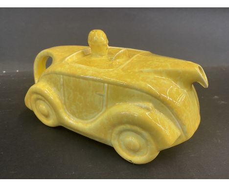 An Art Deco Sadler teapot in the form of a streamlined motor car, yellow version.