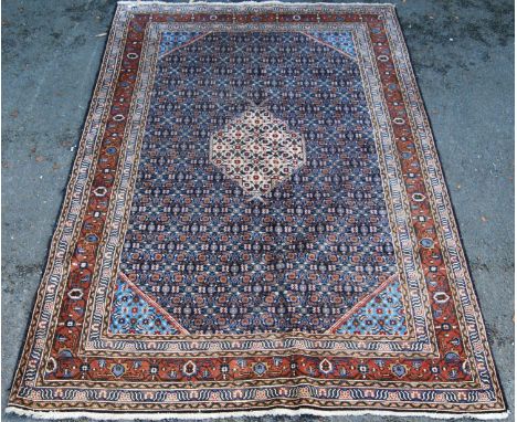 Herati design carpet with central cream diamond, blue ground, spandrels and foliate border, 290cm x 190cm. 