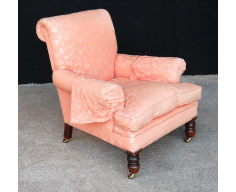 Late 19th century armchair with loose cushioned seat, raised on oak turned legs and ceramic castors, 83cm wide and 86cm high.