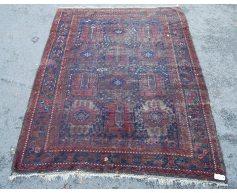 Tekke carpet with three rows of six guls over red ground, triple geometric border, 366cm x 234cm. 