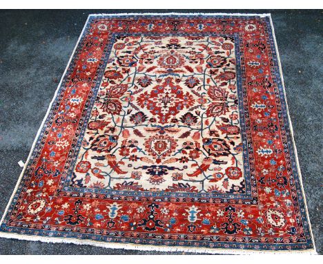 Turkoman carpet with central medallion over cream ground, all over foliate design and red foliate border, 324cm x 270cm. 