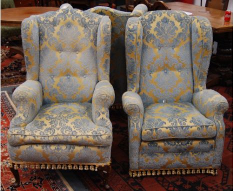 Three wing-back armchairs, each in matching upholstery of gold and light blue floral pattern.
