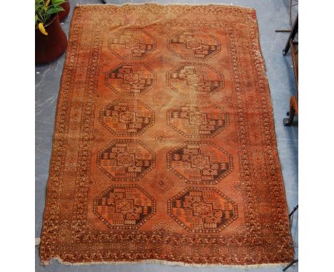 Bokhara carpet with two rows of five guls over faded red ground and geometric border, 232cm x 159cm. 