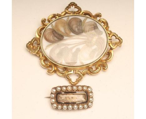 TWO MOURNING BROOCHES, one of plain oblong form with a plaited hair panel within a black enamel and split pearl border, engra