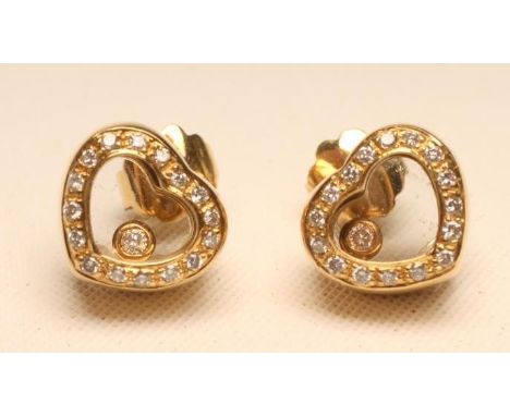 A PAIR OF DIAMOND EAR STUDS, the open heart panels pave set with small diamonds enclosing a Chopard style "floating" diamond 