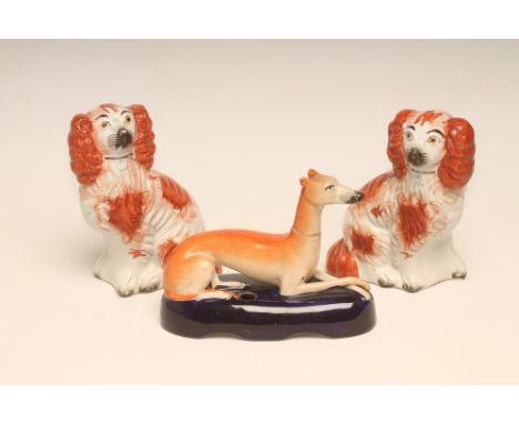 A SMALL PAIR OF VICTORIAN STAFFORDSHIRE POTTERY SPANIELS, with tan markings and gilt collars, 6" high, together with a simila