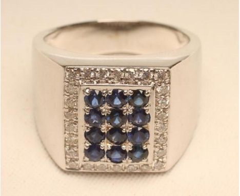 A GENTLEMAN'S SAPPHIRE AND DIAMOND RING, the chequer board panel set with twelve vivid blue small sapphires within a border o