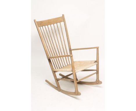 HANS WEGNER FOR FDB MOBLER A J16 ROCKING CHAIR with cord seat, plain comb back with dished top rail, shaped arms, turned upri