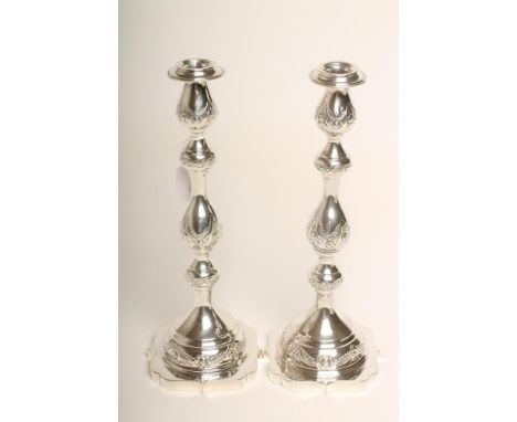 A PAIR OF SILVER SHABBAT CANDLESTICKS, maker possibly M Salkind, London 1931, the detachable drip pans issuing from multi bal