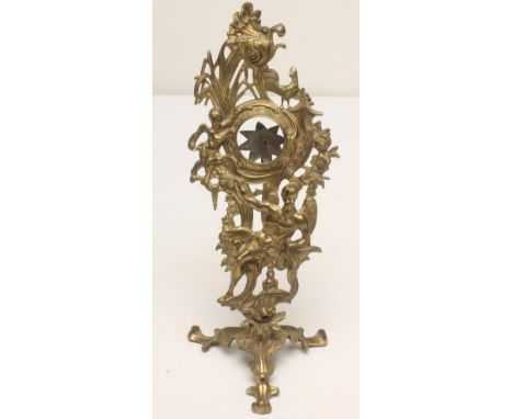 A GEORGIAN ROCOCO BRASS WATCH STAND, c.1760-1770, the circular aperture within a scrolled surround flanked by a cherub amongs