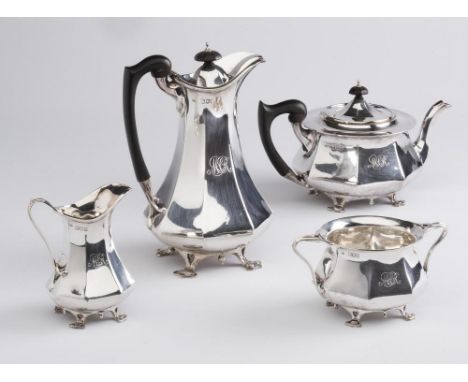 AN EDWARDIAN ARTS AND CRAFTS FOUR PIECE SILVER TEA SERVICE, maker C C Pilling, London 1903, of swept octagonal form raised up