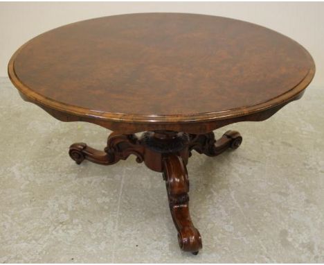 A VICTORIAN WALNUT BREAKFAST TABLE, the burr veneered circular top with waved frieze raised on baluster turned stem with lobe