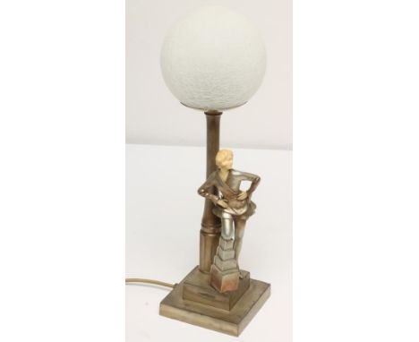 AN ART DECO SILVERED SPELTER FIGURAL TABLE LAMP BASE, modelled as a young lady with ivorine face and hands, wearing a robe wi