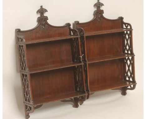 A PAIR OF MAHOGANY WALL BRACKET SHELVES, c.1900, of Georgian chinoiserie design, comprising three graduated bead and reel edg