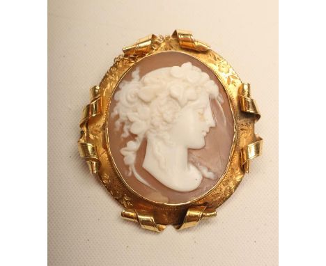 AN EDWARDIAN SHELL CAMEO, the oval panel carved with the head portrait of a young lady wearing her be-ribboned hair up, in an