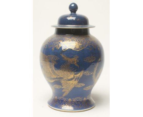 A CHINESE PORCELAIN JAR AND COVER, of inverted baluster form, the powder blue ground over painted in gilt with a phoenix amid