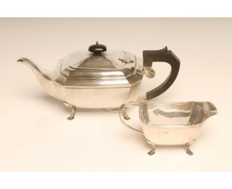 AN ART DECO SILVER TEAPOT AND MILK JUG, maker's mark JR, Birmingham 1931, of canted oblong form, the hinged cover with ebony 