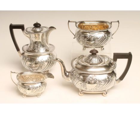 A LATE VICTORIAN FOUR PIECE SILVER TEA SERVICE, makers Martin, Hall & Co., Sheffield 1890, of rounded oblong form, chased and