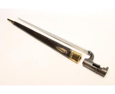 A MARTINI HENRY SOCKET BAYONET, with 17 1/4" triangular section blade and leather scabbard with brass mounts and matching num