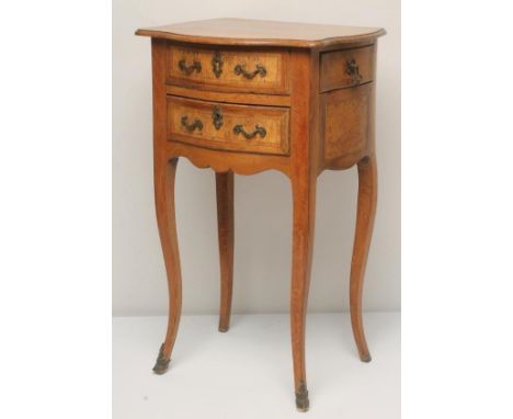 A FRENCH BEECH AND WALNUT PETIT COMMODE, 18th century, of mildly bombe form with moulded edged serpentine top, the fascia wit