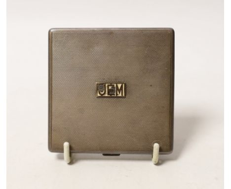 An Elizabeth II engine turned silver square compact, with applied yellow metal initials, 'JEM', W.H. Manton Ltd, Birmingham, 