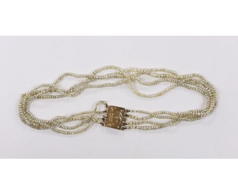 A Regency four (ex five) strand seed pearl choker necklace, with rectangular engraved yellow metal clasp, 37cm.