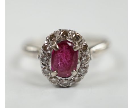 A white metal, synthetic? ruby and diamond set oval cluster ring, size P, gross weight 3.3 grams.
