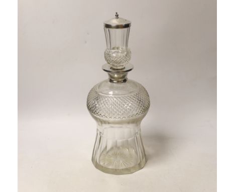 A George V silver mounted cut glass thistle shaped decanter and stopper, Wolfsky &amp; Co Ltd, London, 1927, 29.5cm.