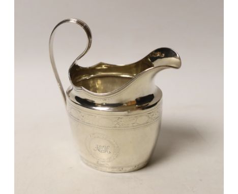 An early 19th century Irish engraved silver cream jug, crowned harp mark only, 13cm, 4.5oz.