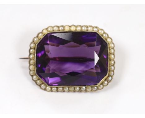 An Edwardian yellow metal mounted emerald cut amethyst and seed pearl cluster set brooch, 31mm, gross weight 11.9 grams.