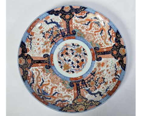 A Japanese Meiji period late 19th Century Imari charger plate of large form having central white enamel cartouche panel depic