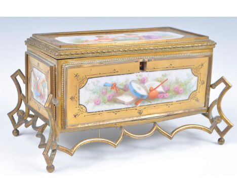 A 19th Century French jewellery casket box in the manner or Sevres raised on shaped gilt brass ormolu base with hand painted 